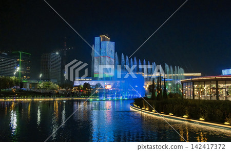 A Tashkent City skyscraper is illuminated with Uzbekistan's flag colors A Tashkent City skyscraper is illuminated with Uzbekistan's flag colors 142417372