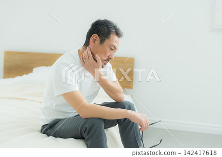 Middle-aged men struggling with bed-related issues Middle-aged men struggling with bed-related issues 142417618