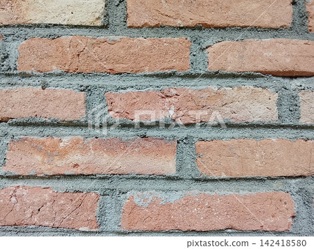 Red brick wall texture with grey cement mortar in close up front view Red brick wall texture with grey cement mortar in close up front view 142418580