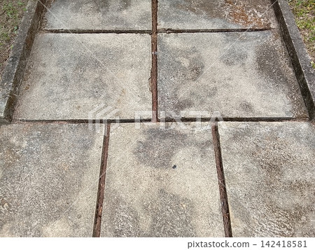 Concrete paving slabs texture on a garden pathway in top view high angle shot Concrete paving slabs texture on a garden pathway in top view high angle shot 142418581
