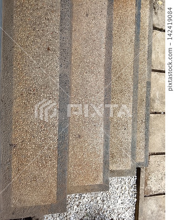 Pebble stone stairs with two tone textured steps in a high angle top view 142419084