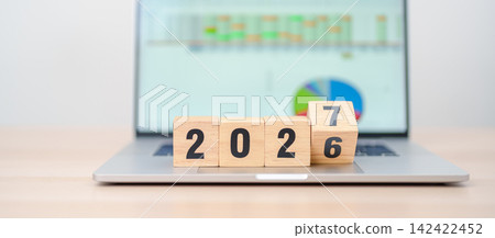 2026 end year to Happy New Year 2027 block with computer laptop background. Goal, Target, Resolution, strategy, plan, Action, mission, motivation, and New Year start concepts 142422452