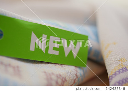 New label on fabric in a retail setting New label on fabric in a retail setting 142422846
