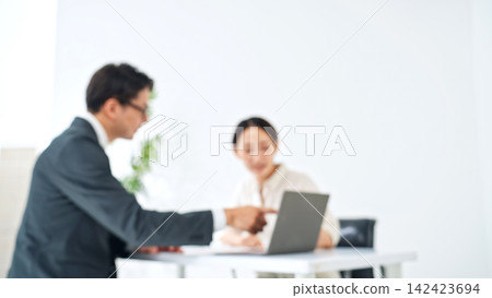 A man and a woman having a meeting. Blurred image for illustrative purposes. Customer service, consultation, business, sales, customer, B2C, handshake, contract, sales. A man and a woman having a meeting. Blurred image for illustrative purposes. Customer service, consultation, business, sales, customer, B2C, handshake, contract, sales. 142423694