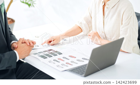 A man and a woman having a meeting. Customer service, consultation, business, sales, customer, meeting, sales, smile, explanation, proposal, B2C, sales, customer service. A man and a woman having a meeting. Customer service, consultation, business, sales, customer, meeting, sales, smile, explanation, proposal, B2C, sales, customer service. 142423699