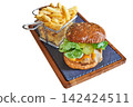 Chicken Hamburger and basket of fries on a board 142424511