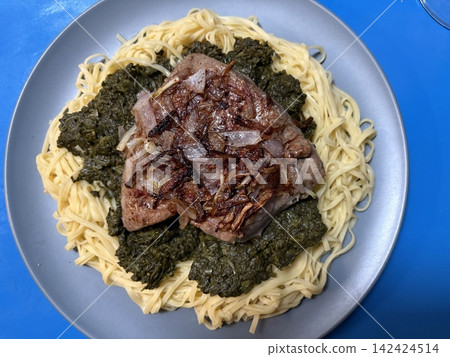 Veal liver with shallots on a bed of Taglionelli and spinach Veal liver with shallots on a bed of Taglionelli and spinach 142424514