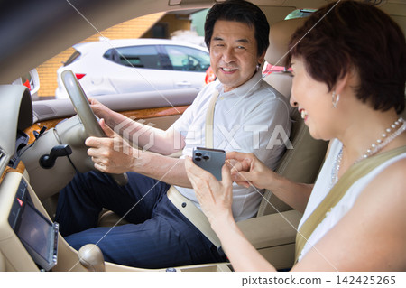 A senior couple going out in their car A senior couple going out in their car 142425265