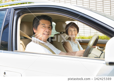 A senior couple going out in their car A senior couple going out in their car 142425389