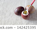 Passion fruit scooped with spoon 142425395
