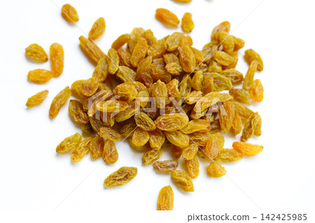 Golden green raisins piled on white Golden green raisins piled on white 142425985