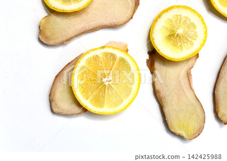 Slices of fresh ginger and lemon isolated on white background Slices of fresh ginger and lemon isolated on white background 142425988