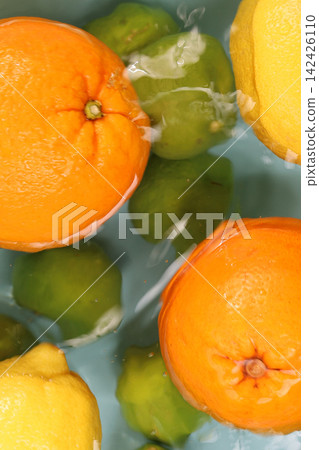 Fresh oranges, lemons, and limes floating in clean rippling water. Fresh oranges, lemons, and limes floating in clean rippling water. 142426110