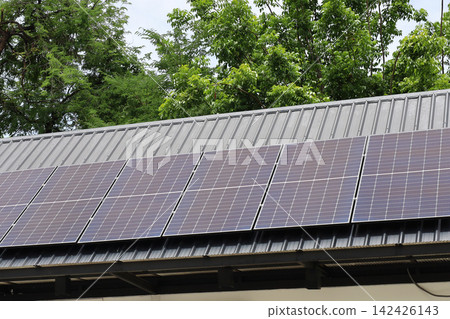 Solar panels installed on a corrugated metal roof Solar panels installed on a corrugated metal roof 142426143