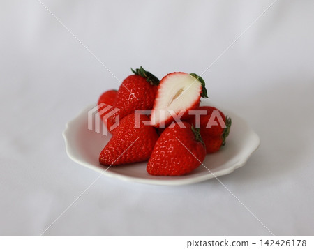 strawberries on a white plate strawberries on a white plate 142426178