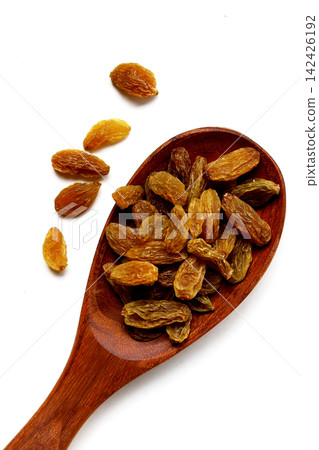 Golden green raisins piled on white Golden green raisins piled on white 142426192