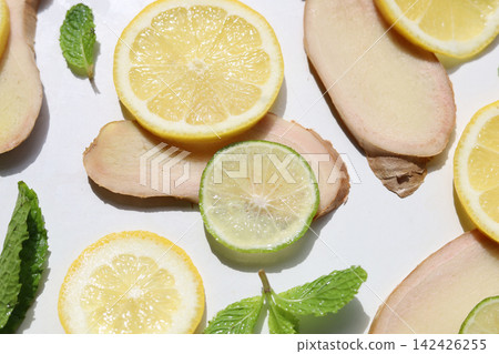 Healthy ingredients featuring yellow lemon, green lime, fresh ginger, and mint Healthy ingredients featuring yellow lemon, green lime, fresh ginger, and mint 142426255