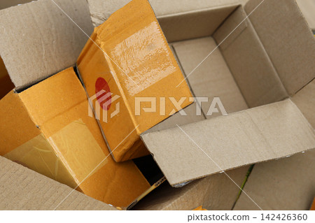 Pile of used open cardboard parcel boxes for recycling 142426360