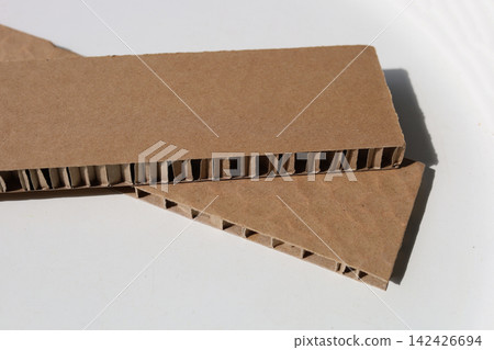 Thick brown honeycomb paper padding for shockproof product packaging. Thick brown honeycomb paper padding for shockproof product packaging. 142426694