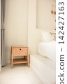 Wooden Bedside Table Beside a Bed in Chonburi, Thailand 142427163