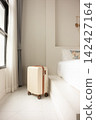 Suitcase Beside a Bed in a Bright Room in Chonburi, Thailand 142427164
