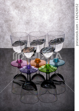 Still life with liquid in glasses on a gray background Still life with liquid in glasses on a gray background 142428452