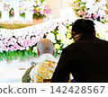 Ceremony ladies bowing towards the altar 142428567
