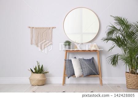 Round mirror and plants at home. Idea for interior design Round mirror and plants at home. Idea for interior design 142428805
