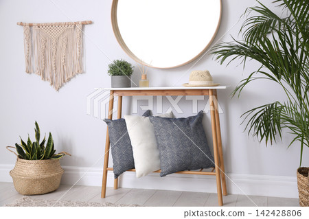 Round mirror and wooden table at home. Idea for interior design Round mirror and wooden table at home. Idea for interior design 142428806