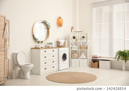 Interior of stylish bathroom with washing machine 142428814