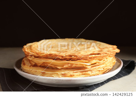 Stack of fresh thin pancakes on table Stack of fresh thin pancakes on table 142429125