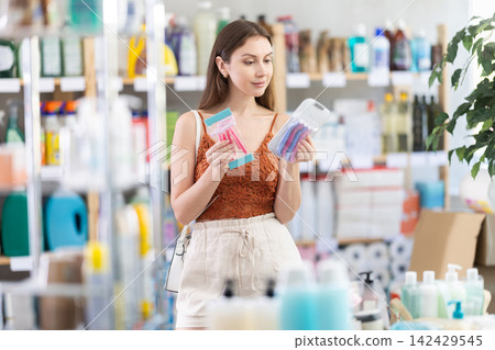 Young woman choosing razor in store Young woman choosing razor in store 142429545