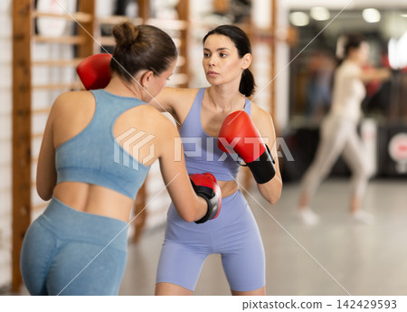 Young women in gym boxing training 142429593