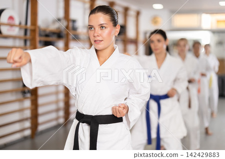 Young women during group karate training Young women during group karate training 142429883