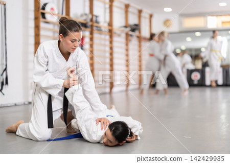 Women in kimono at judo gym training Women in kimono at judo gym training 142429985
