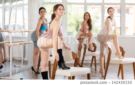 Young girl performing sass dance with chair at group class Young girl performing sass dance with chair at group class 142430150