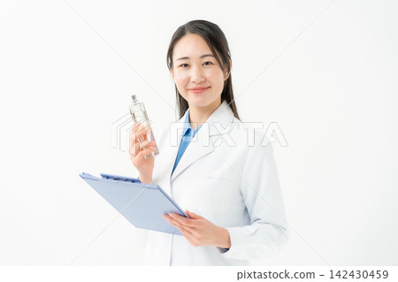 Woman in a white coat, researcher, fragrance Woman in a white coat, researcher, fragrance 142430459