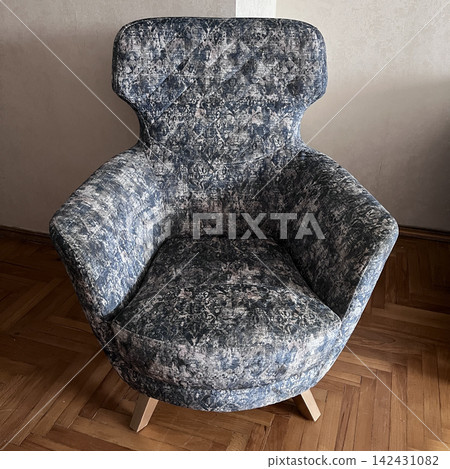 Patterned upholstered armchair in living room 142431082