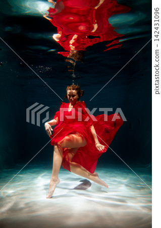 Flowing dress and dramatic lighting evoke cinematic water scene mood Flowing dress and dramatic lighting evoke cinematic water scene mood 142431096