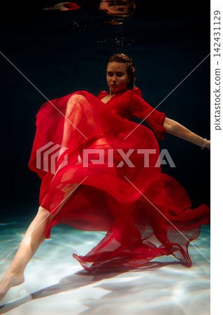 Chic Caucasian model exudes confidence in striking red ensemble underwater Chic Caucasian model exudes confidence in striking red ensemble underwater 142431129