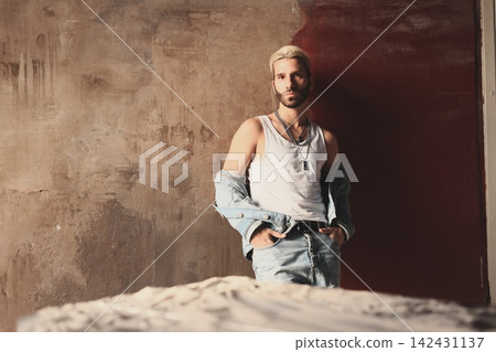 Stylish person showcasing relaxed clothing with bold expression 142431137