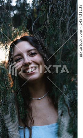 Portrait of a very beautiful young woman in a summer spruce forest at sunset. Portrait of a very beautiful young woman in a summer spruce forest at sunset. 142431138
