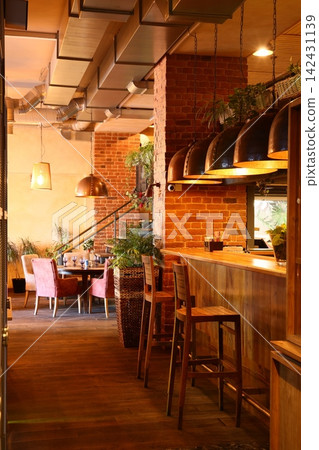Relaxed evening setting featuring wooden textures and muted plants Relaxed evening setting featuring wooden textures and muted plants 142431139