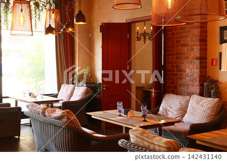 Cozy cafe entrance. Charming doorway with friendly ambiance and plants Cozy cafe entrance. Charming doorway with friendly ambiance and plants 142431140