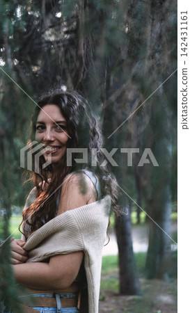 Portrait of a very beautiful young woman in a summer spruce forest at sunset. Portrait of a very beautiful young woman in a summer spruce forest at sunset. 142431161