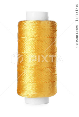 Spool of yellow sewing thread isolated on white 142431240