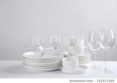 Set of clean dishes on white table Set of clean dishes on white table 142431268
