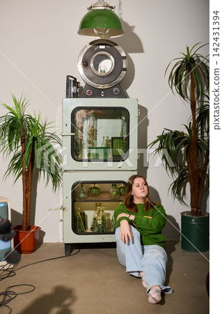 Portrait of serene lady amid vintage washing machine and plants Portrait of serene lady amid vintage washing machine and plants 142431394