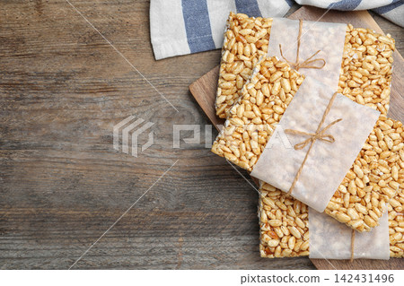 Delicious rice crispy treats on wooden table, top view. Space for text 142431496