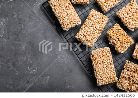 Delicious rice crispy treats on grey table, flat lay. Space for text Delicious rice crispy treats on grey table, flat lay. Space for text 142431500